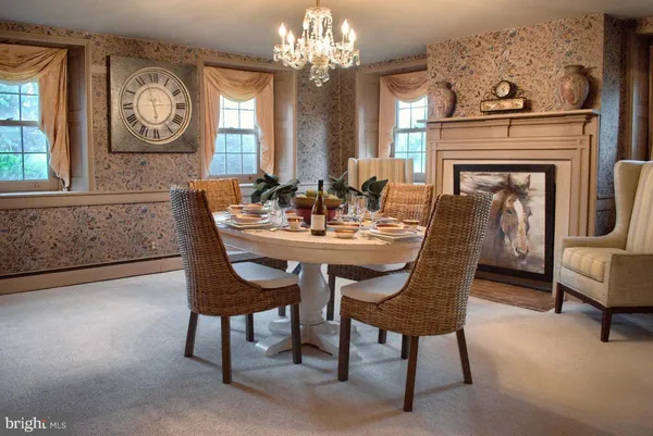 a view of a dining room with furniture and a chandelier