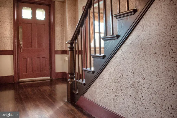 a view of entryway with wooden floor and stairs