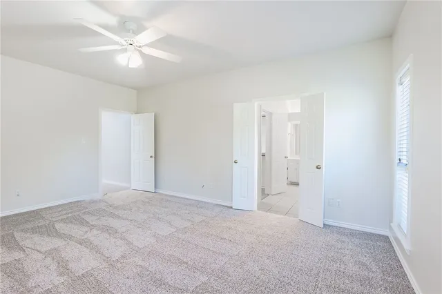 a view of an empty room with a fan