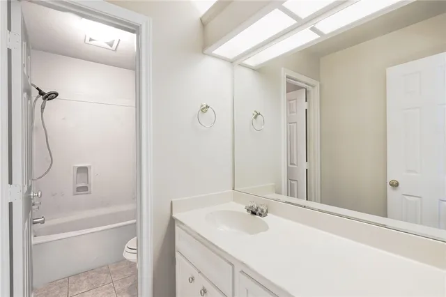 a bathroom with a sink vanity tub and shower