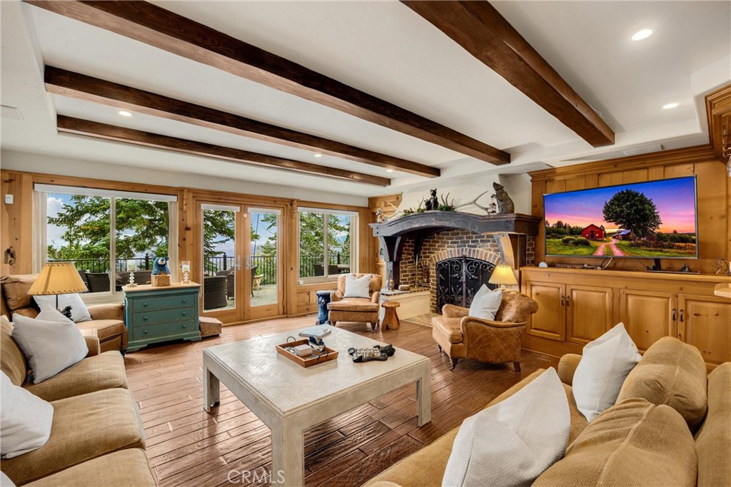 29162 Bald Eagle Ridge Road Lake Arrowhead, CA 92352 - Photo 18 of 69 a living room with furniture fireplace and a large window