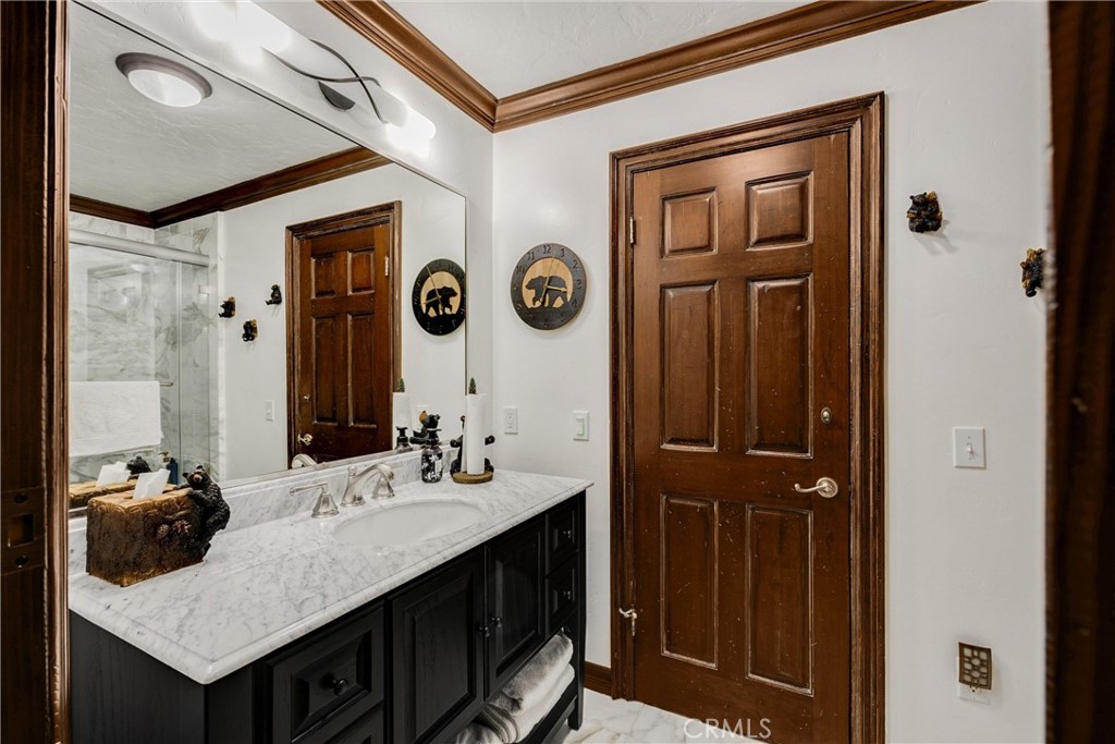 29162 Bald Eagle Ridge Road Lake Arrowhead, CA 92352 - Photo 24 of 69 a bathroom with a sink a mirror and a shower