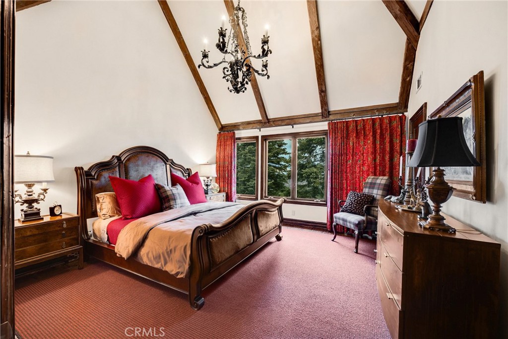 29162 Bald Eagle Ridge Road Lake Arrowhead, CA 92352 - Photo 27 of 69 a bedroom with a bed and a flat tv screen on wall