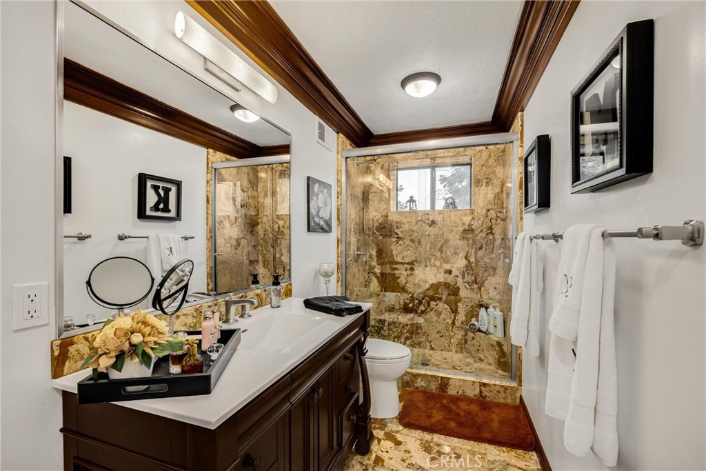 29162 Bald Eagle Ridge Road Lake Arrowhead, CA 92352 - Photo 32 of 69 a bathroom with a sink a toilet and shower