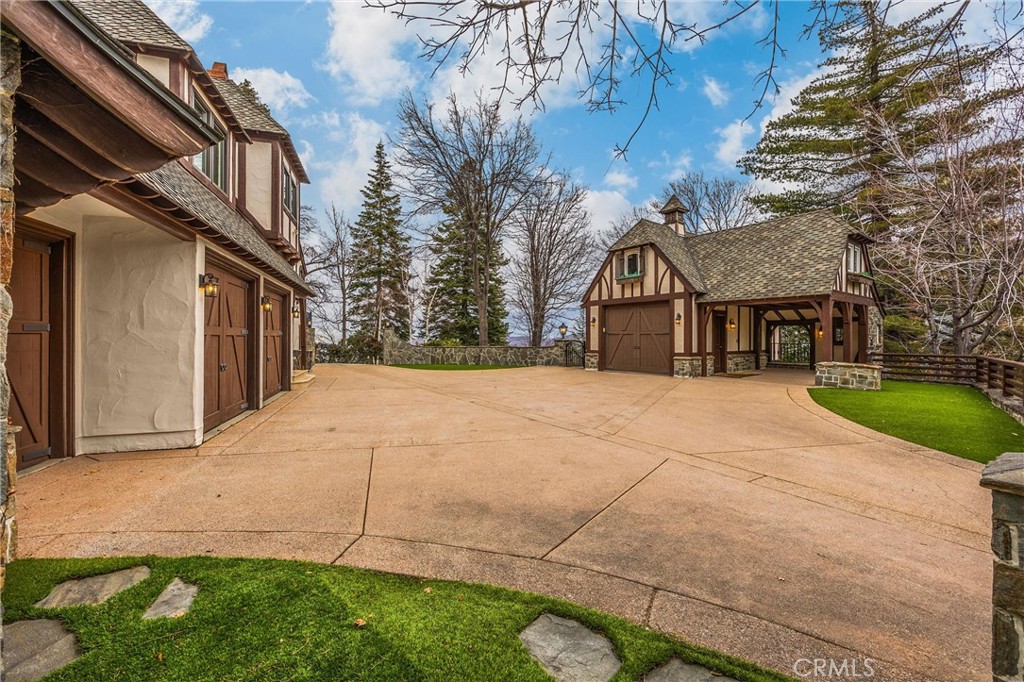 29162 Bald Eagle Ridge Road Lake Arrowhead, CA 92352 - Photo 39 of 69 a front view of a house with a yard and garage