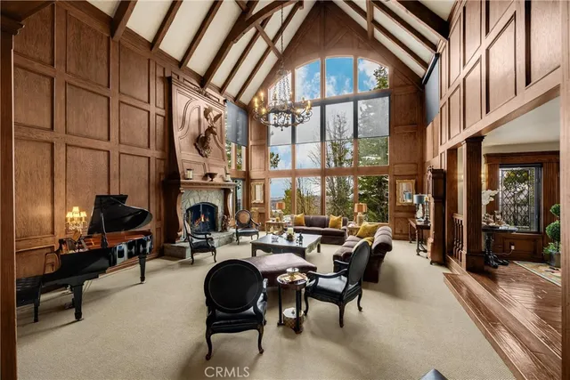 a living room with furniture a fireplace and a table
