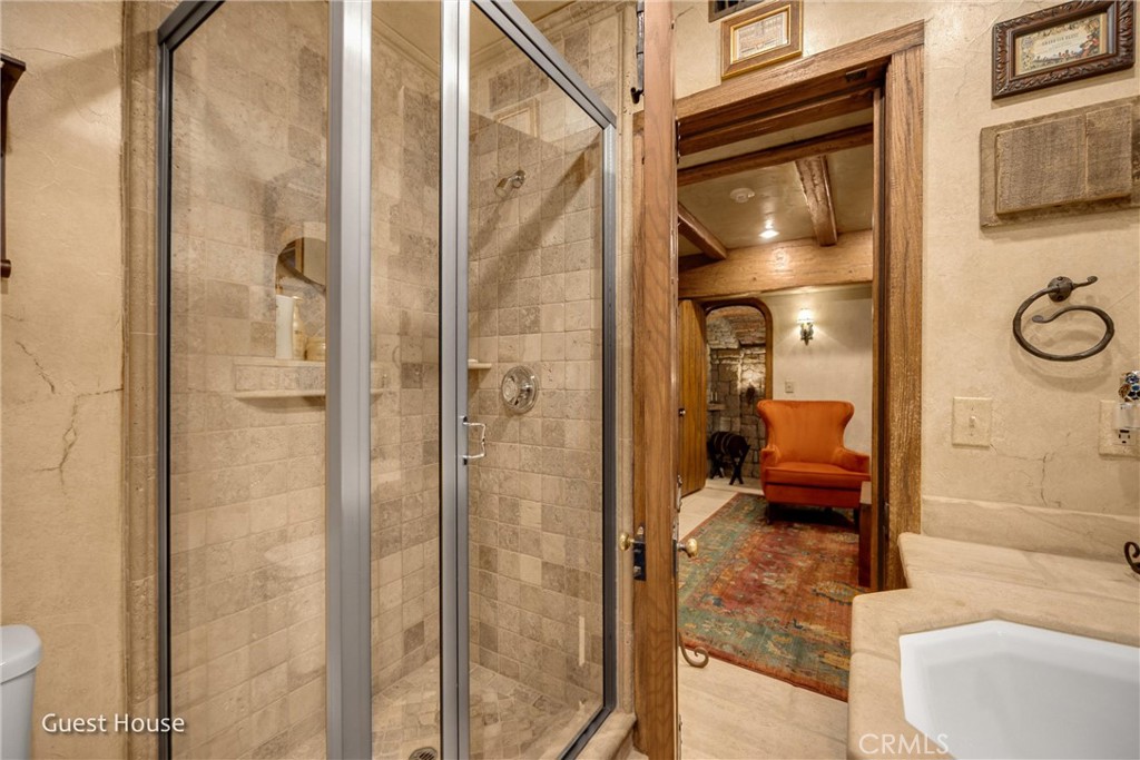 29162 Bald Eagle Ridge Road Lake Arrowhead, CA 92352 - Photo 56 of 69 a en suite bathroom with a granite countertop shower and a sink