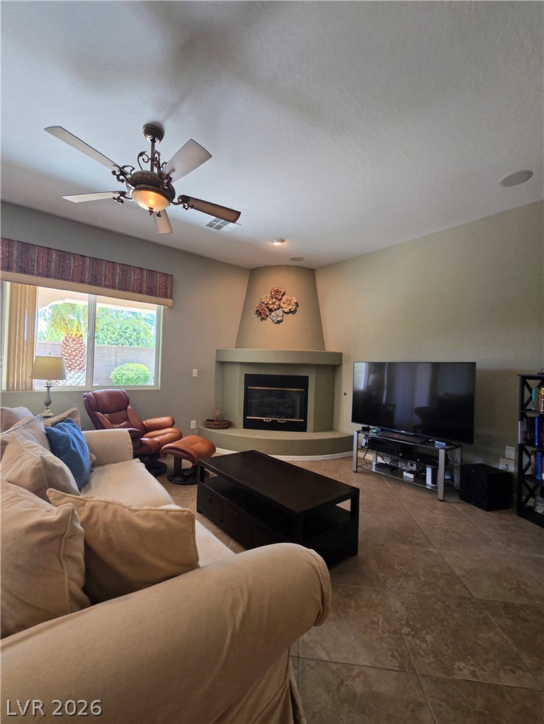 2567 Dirleton Place Henderson, NV 89044 - Photo 24 of 67 A corner fireplace creates a focal point in this inviting living room.