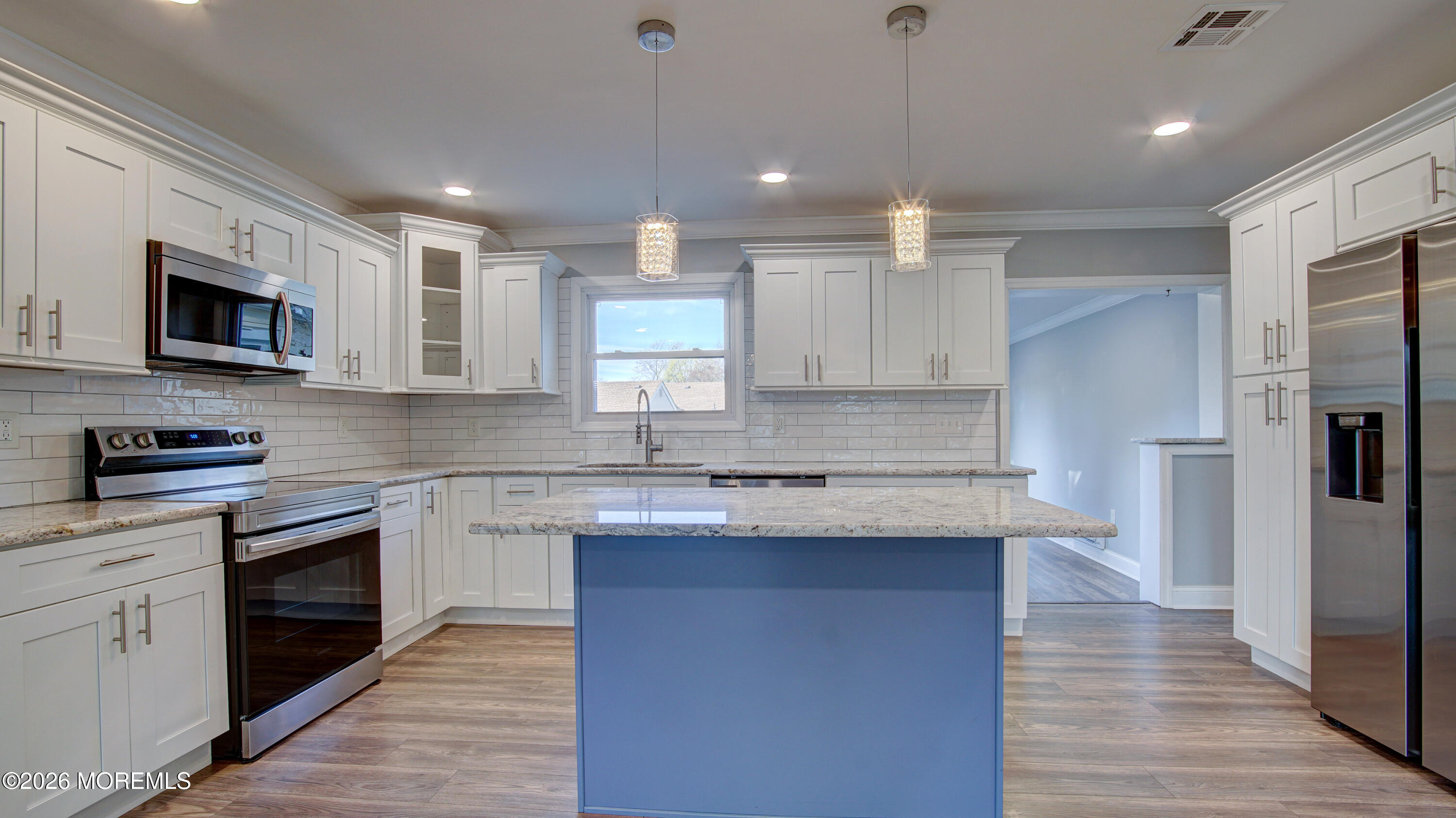 10 Zacatin Road, Unit B Freehold, NJ 07728 - Photo 11 of 39 a kitchen with stainless steel appliances granite countertop a stove top oven a sink dishwasher a refrigerator and a oven with wooden floor