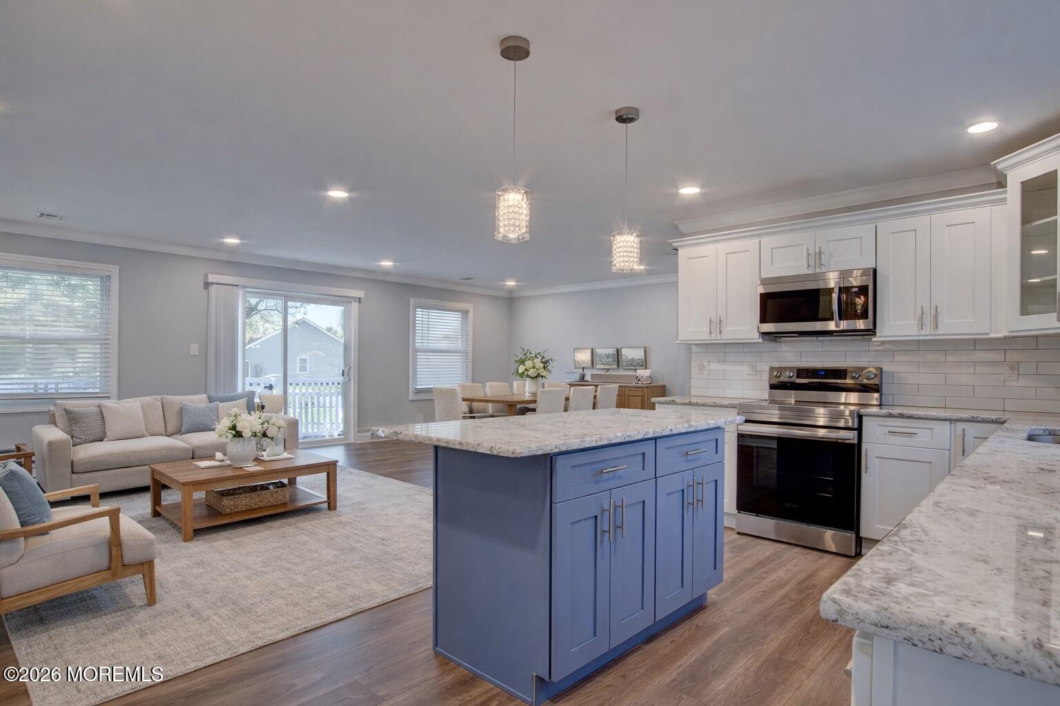 10 Zacatin Road, Unit B Freehold, NJ 07728 - Photo 14 of 39 a kitchen with stainless steel appliances granite countertop wooden cabinets a sink dishwasher a stove and a refrigerator with wooden floor