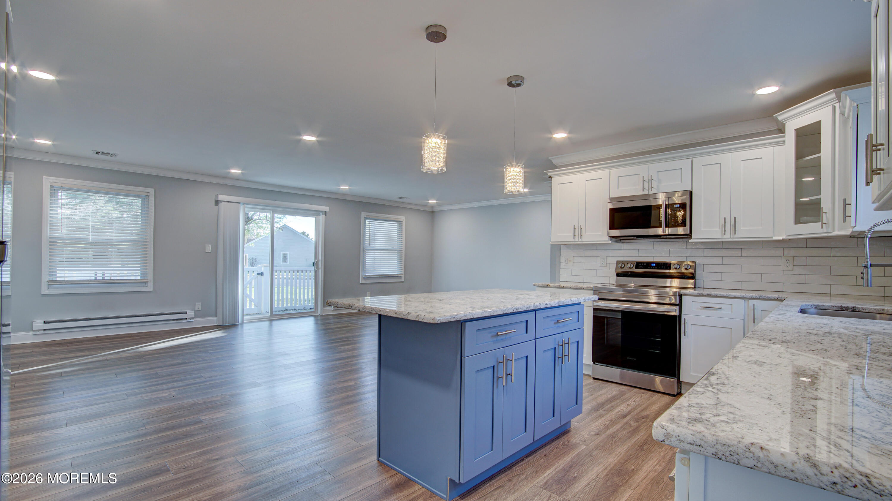 10 Zacatin Road, Unit B Freehold, NJ 07728 - Photo 15 of 39 a kitchen with stainless steel appliances granite countertop a stove a sink dishwasher and a microwave oven with wooden floor
