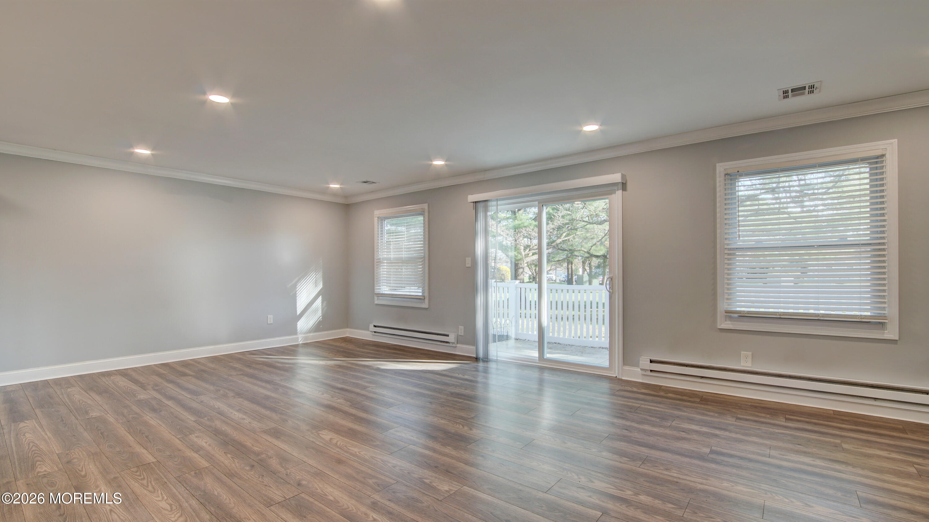10 Zacatin Road, Unit B Freehold, NJ 07728 - Photo 17 of 39 a view of an empty room with wooden floor and a window