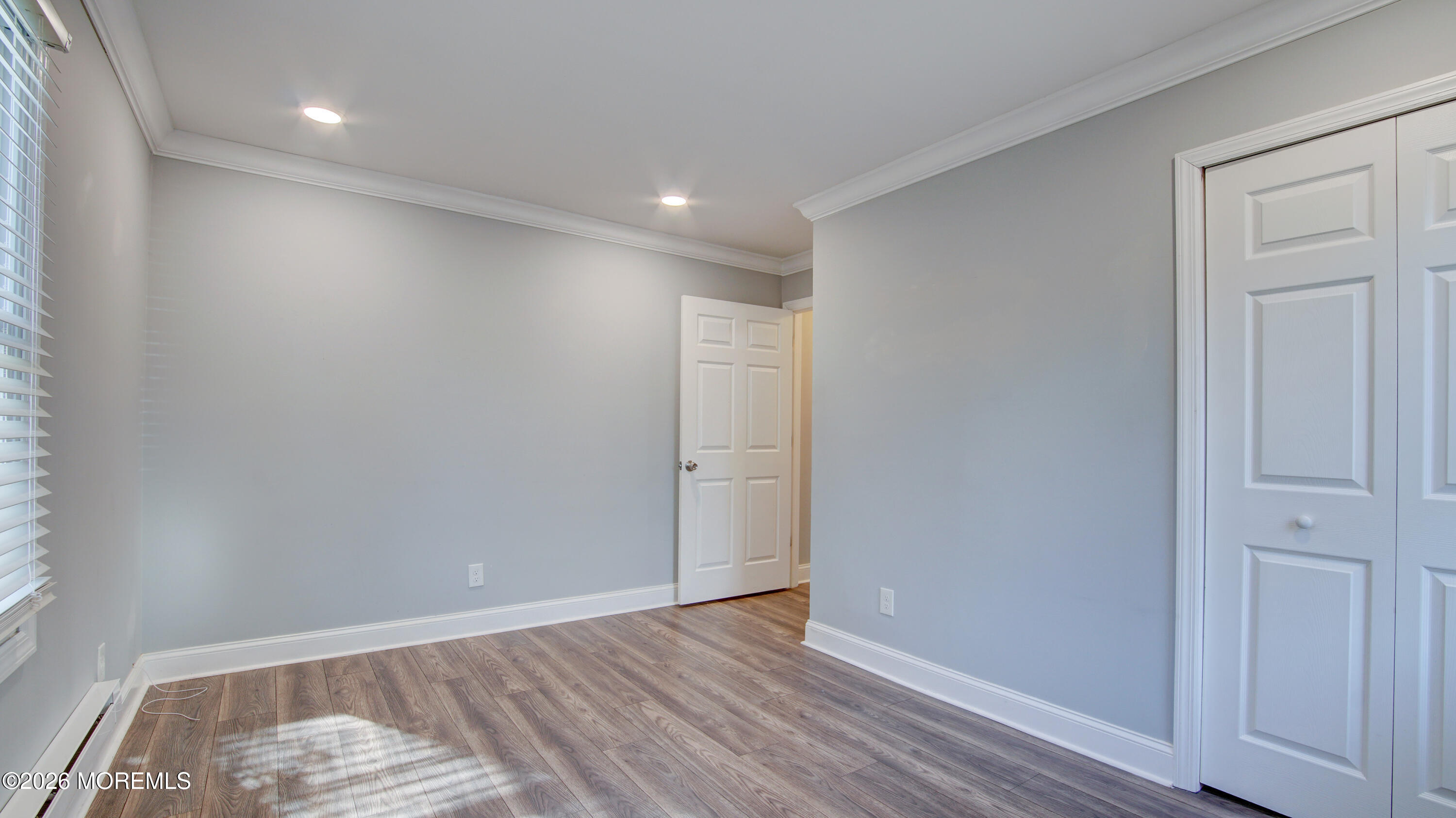 10 Zacatin Road, Unit B Freehold, NJ 07728 - Photo 29 of 39 wooden floor in an empty room with a window