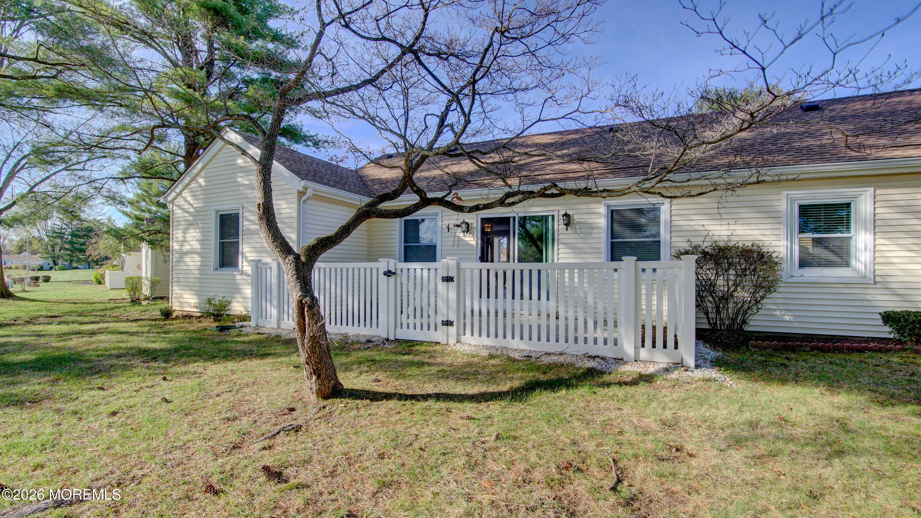 10 Zacatin Road, Unit B Freehold, NJ 07728 - Photo 36 of 39 a view of a house with a small yard and wooden fence