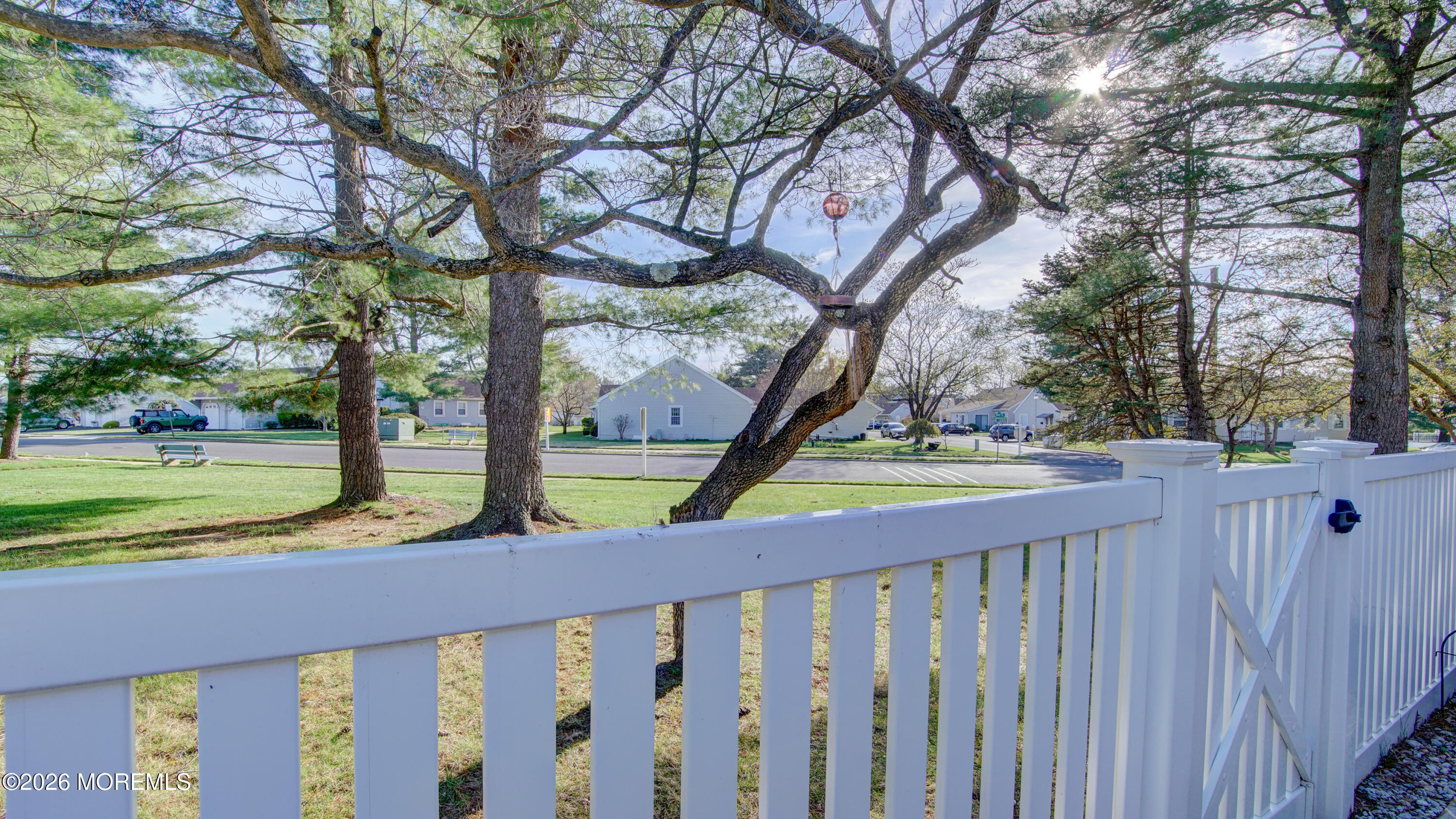 10 Zacatin Road, Unit B Freehold, NJ 07728 - Photo 37 of 39 a view of a yard with a tree and wooden fence