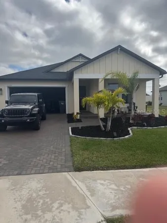 a front view of a house with a garden and patio