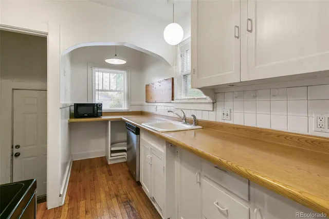 a kitchen with a sink and cabinets