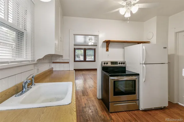 a kitchen with granite countertop a sink and a stove top oven