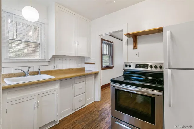 a kitchen with cabinets appliances and a sink