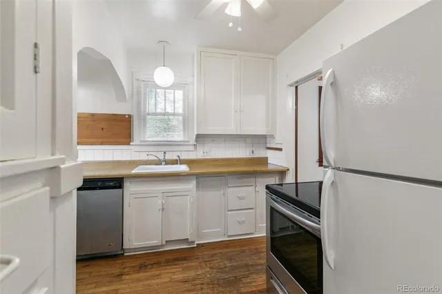 a kitchen with a sink appliances and cabinets