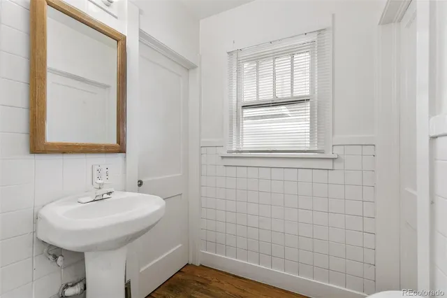 a bathroom with a sink a window and a mirror