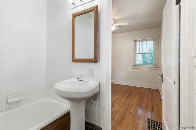 a bathroom with a sink a toilet and mirror