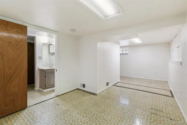 an empty room with a empty space and windows