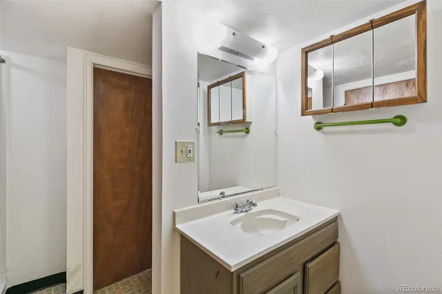 a bathroom with 2 sink and a mirror