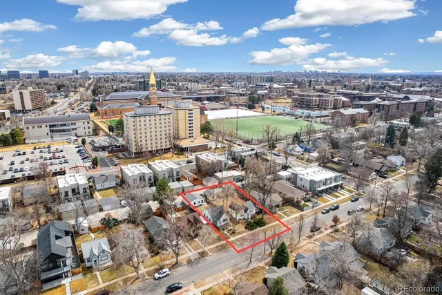 a view of a big yard with a house in the background