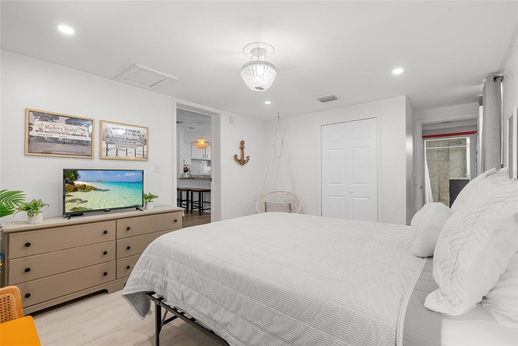4939 100th Way North St. Petersburg, FL 33708 - Photo 17 of 43 a bedroom with a bed and a dresser