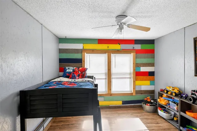 a living room with furniture and a ceiling fan