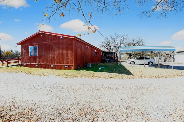 a view of a house with a yard and garage
