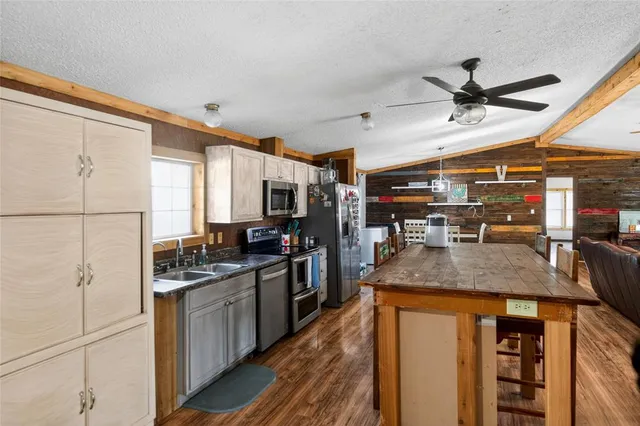 a kitchen with stainless steel appliances granite countertop a sink and cabinets