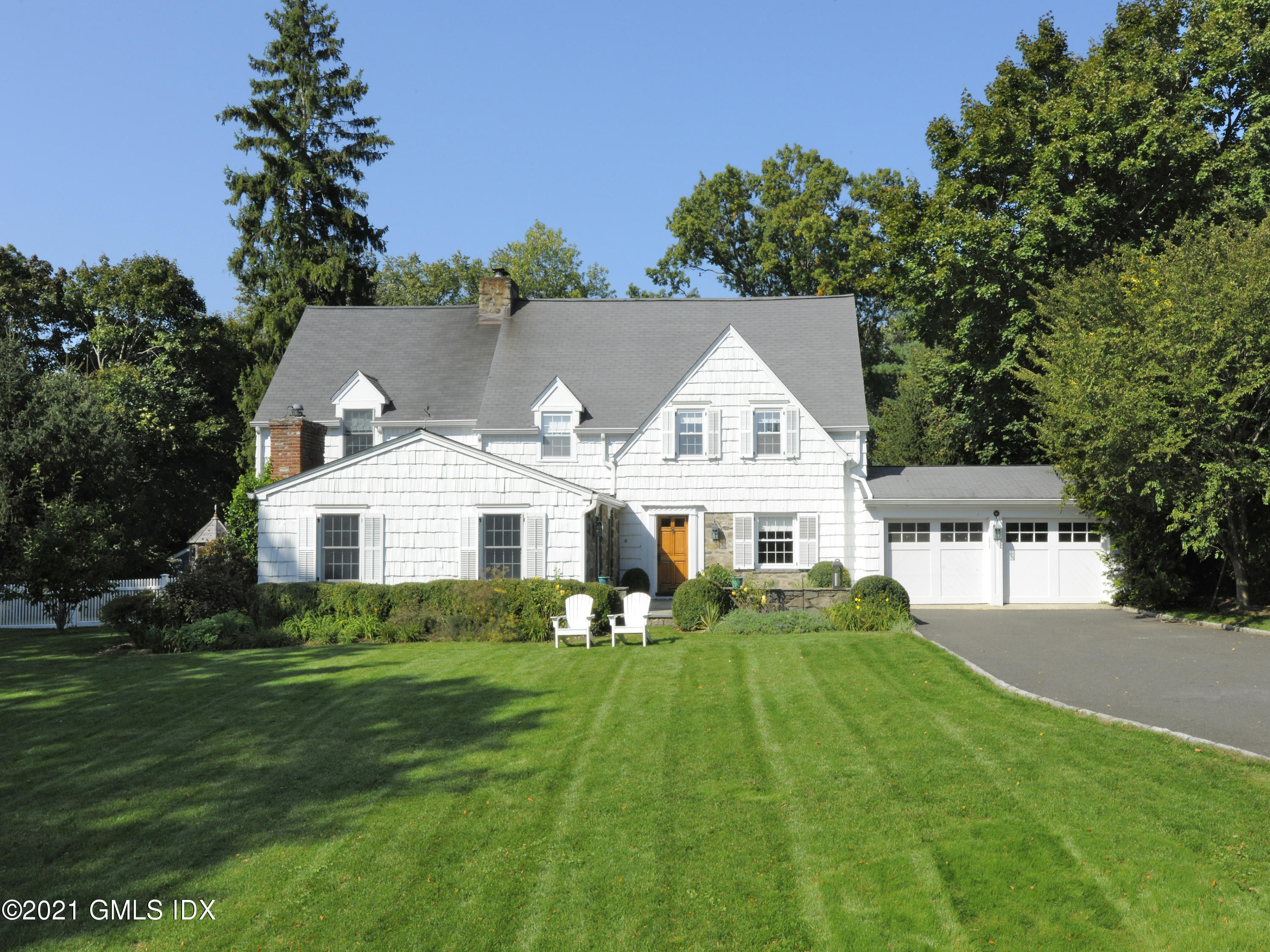 3 Random Road Old Greenwich, CT 06870 - Photo 2 of 28 a front view of a house with a garden