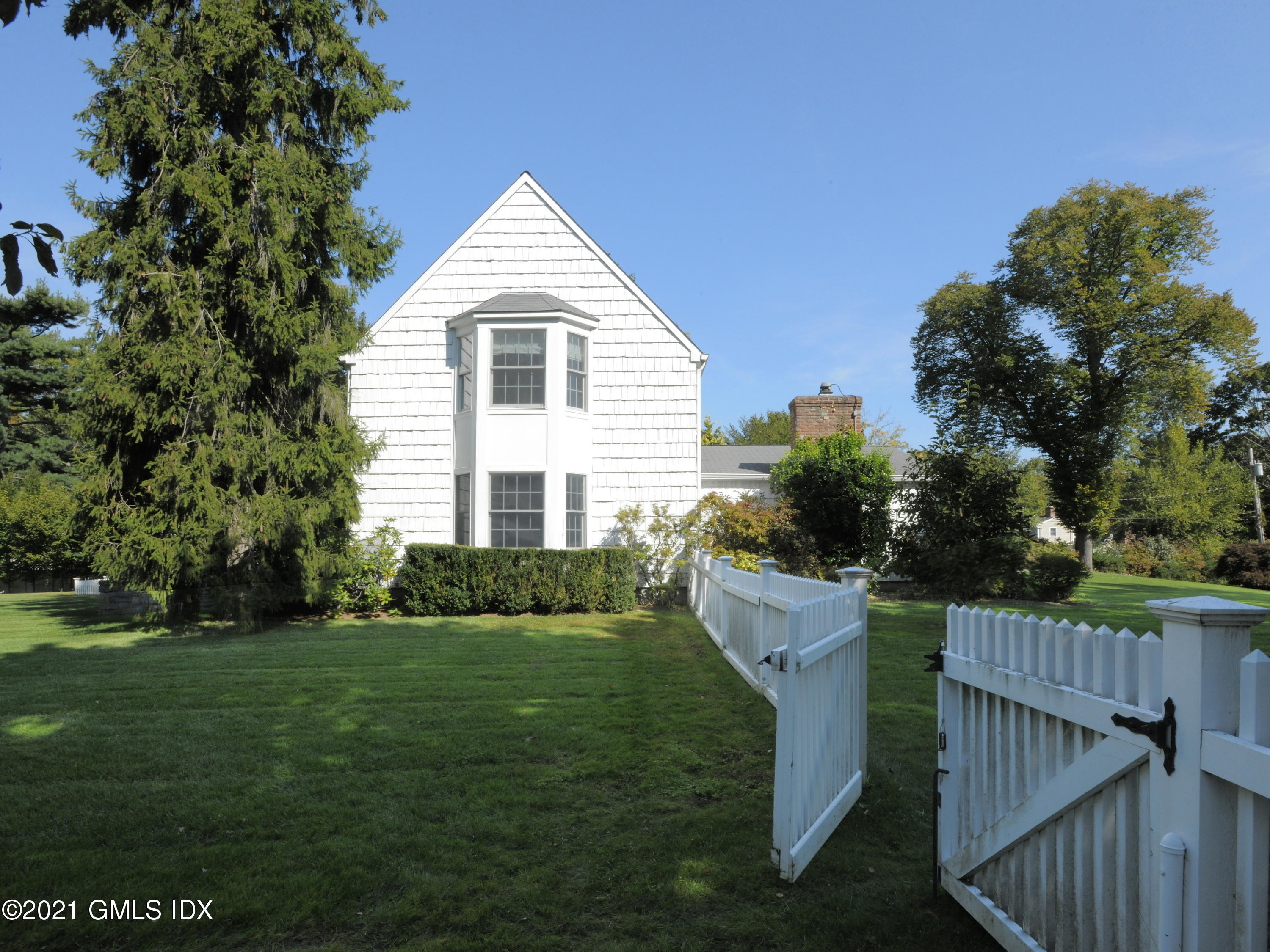 3 Random Road Old Greenwich, CT 06870 - Photo 23 of 28 a front view of a house with a yard