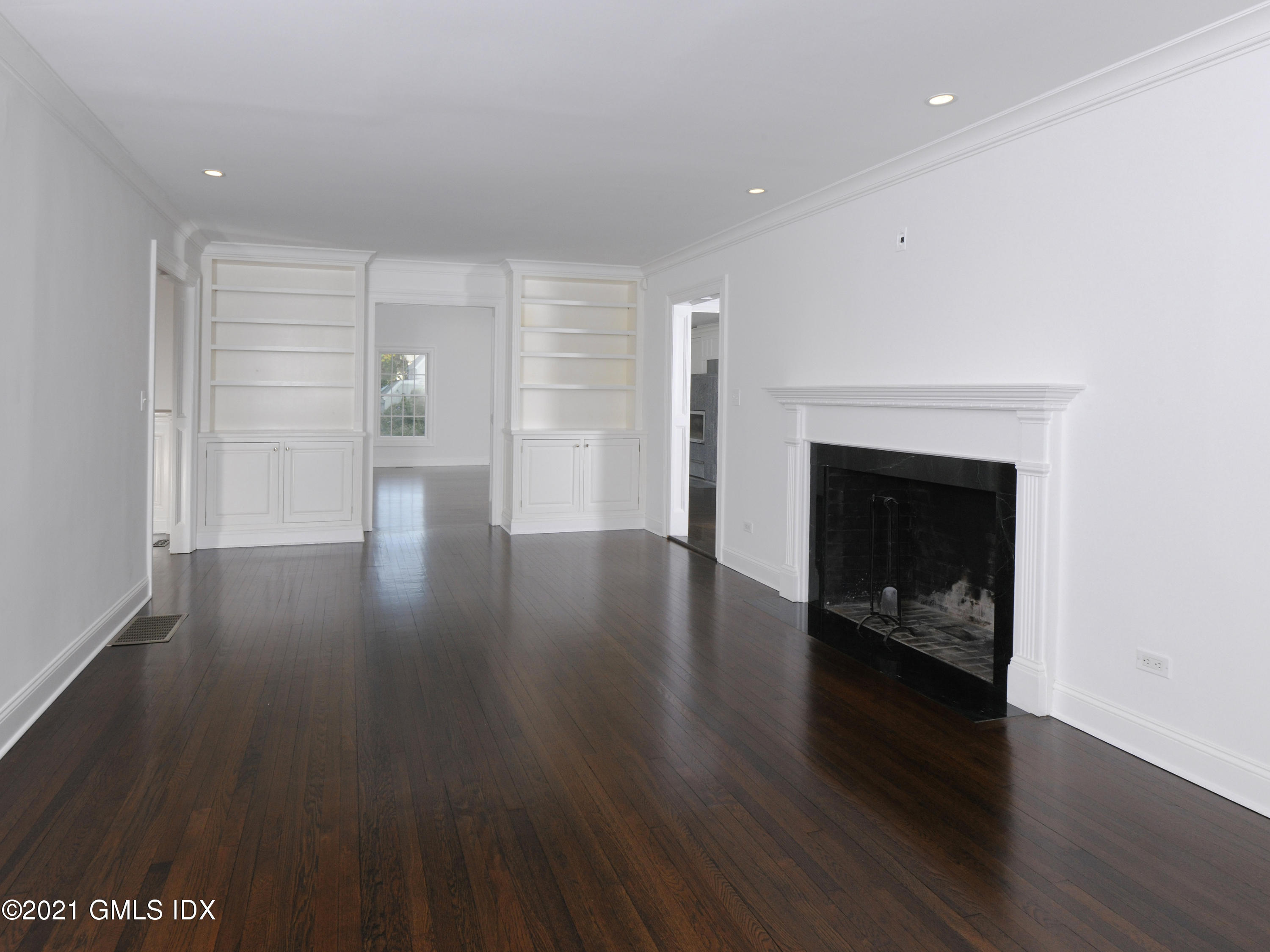 3 Random Road Old Greenwich, CT 06870 - Photo 4 of 28 a view of an empty room with wooden floor fireplace and a window