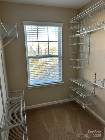 a bathroom with a window and a shower
