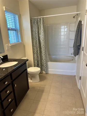 a bathroom with a double vanity sink toilet and shower