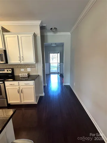 a view of a kitchen with a sink wooden floor and a window