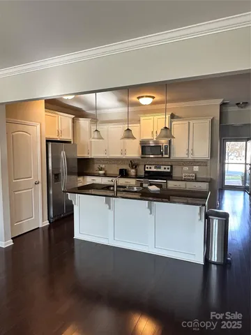 a kitchen with stainless steel appliances a refrigerator and wooden cabinets
