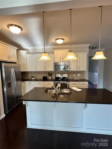 a kitchen with counter top space cabinets and stainless steel appliances