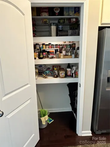 a shelf with wine bottles and glasses on it