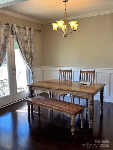 a view of a dining room with furniture wooden floor and chandelier