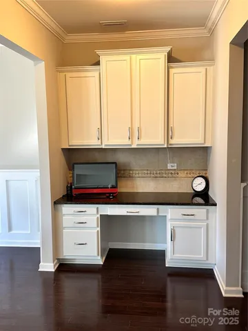 a kitchen with granite countertop a stove a sink and a microwave