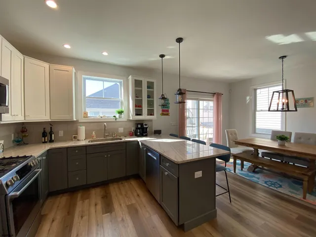 a kitchen with stainless steel appliances granite countertop sink stove and window