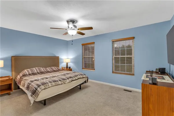 a bedroom with a bed dresser and a window