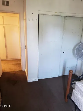 a bedroom with a bed and a lamp