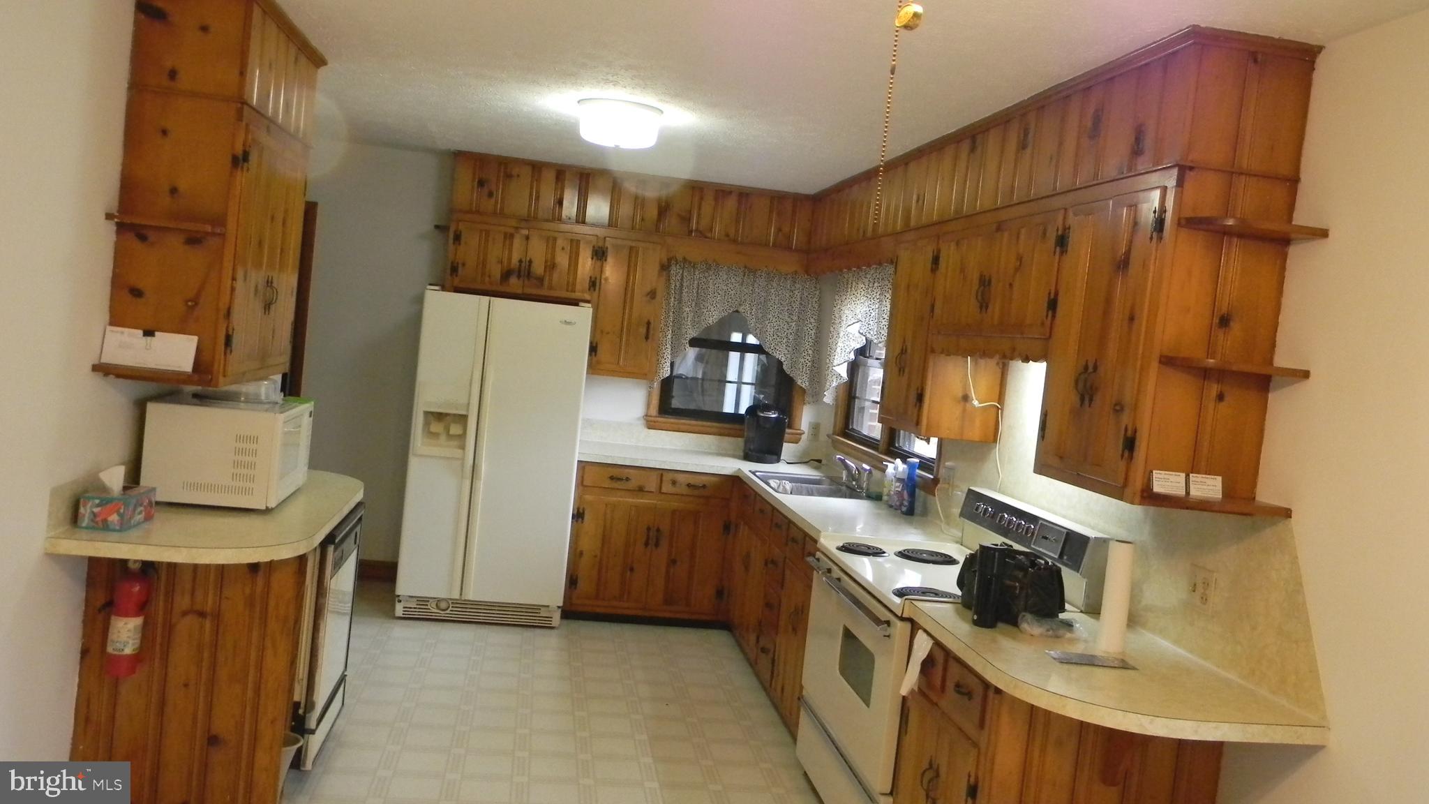 6688 Brocks Gap Road Broadway, VA 22815 - Photo 23 of 81 a kitchen with stainless steel appliances granite countertop a refrigerator a stove and a sink with wooden floor