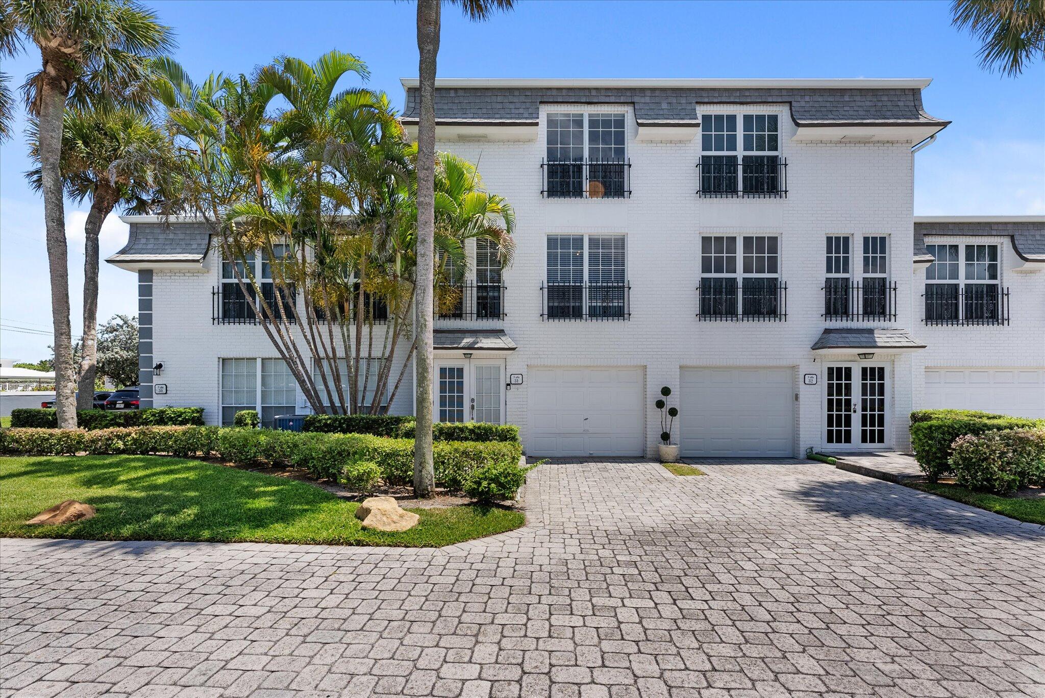 1194 Hillsboro Mile, Unit 31 Hillsboro Beach, FL 33062 - Photo 1 of 47 a front view of a house with a yard