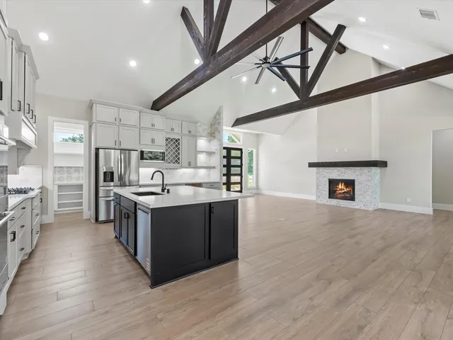 a spacious bedroom with a bed and a flat screen tv